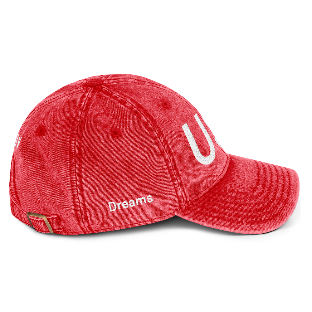 Red cap with 'Dreams' and a white logo on a white background